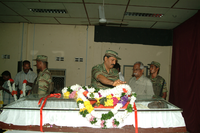 Head of LTTE Intelligence Division, Poddu Ammaan, garlanding the remains of Sivanesan MP