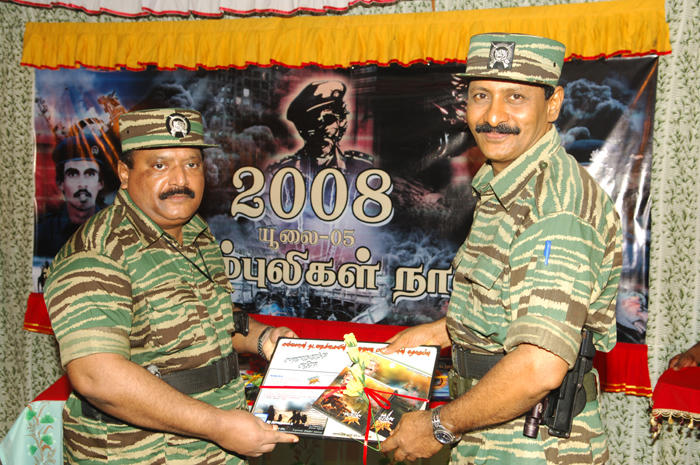 Mr. Pirapaharan receiving the first copy of 'Surprise Attack in Anuradhapuram', a music album, from Poddu Ammaan, head of LTTE intelligence wing